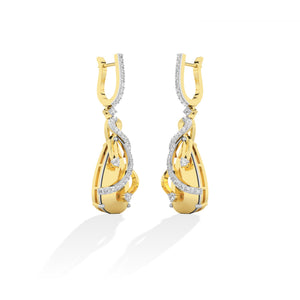 Round Lab-Grown Diamond Earrings in 18K yellow gold, worn on model | Binson Diamonds