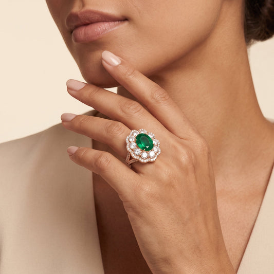 Binson Diamonds rose gold ring featuring a large oval emerald surrounded by a halo of round lab-grown diamonds